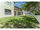 A spacious, lush backyard with a screened lanai and a second-story balcony, perfect for outdoor relaxation at 1778 Waterside Oaks Dr, Orange City, FL 32763