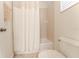 Bright bathroom with a tub-shower combo behind a curtain and a white toilet at 1778 Waterside Oaks Dr, Orange City, FL 32763
