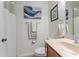 Cozy bathroom featuring a marble sink vanity, decorative artwork, and neutral tones at 1778 Waterside Oaks Dr, Orange City, FL 32763