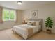 Cozy staged bedroom showcasing a neutral color palette, plush rug, and natural light from the window at 1778 Waterside Oaks Dr, Orange City, FL 32763