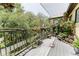 Inviting wooden deck with metal railings, complemented by lush greenery and colorful flowers at 1778 Waterside Oaks Dr, Orange City, FL 32763