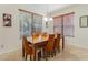 Bright dining room featuring a wooden table, six chairs, and large windows with wood blinds at 1778 Waterside Oaks Dr, Orange City, FL 32763