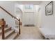 Bright foyer featuring tile flooring, arched doorways and staircase with wood railing at 1778 Waterside Oaks Dr, Orange City, FL 32763