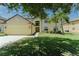 Charming two-story home featuring mature trees, lush lawn and a two car garage at 1778 Waterside Oaks Dr, Orange City, FL 32763