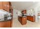 Spacious kitchen boasts cherry cabinets, granite counters, and stainless appliances at 1778 Waterside Oaks Dr, Orange City, FL 32763