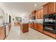 Stylish kitchen features wood cabinets, granite countertops, and stainless steel appliances at 1778 Waterside Oaks Dr, Orange City, FL 32763