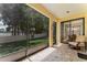 Covered patio with seating overlooking the yard and lake at 1778 Waterside Oaks Dr, Orange City, FL 32763