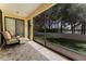 Covered outdoor lanai with scenic backyard views and comfortable seating at 1778 Waterside Oaks Dr, Orange City, FL 32763