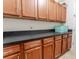 Laundry room featuring wood cabinets, black countertops, and tiled floors at 1778 Waterside Oaks Dr, Orange City, FL 32763