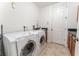 Bright laundry room featuring a modern, front-loading washer and dryer set at 1778 Waterside Oaks Dr, Orange City, FL 32763