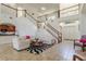 Open-concept living room with staircase, tile flooring, and large windows, creating a bright, airy atmosphere at 1778 Waterside Oaks Dr, Orange City, FL 32763