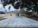 Spacious backyard featuring a large concrete patio, perfect for outdoor entertaining and relaxation at 1912 Conch Ln, Kissimmee, FL 34759