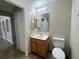 Bathroom featuring a vanity, toilet, and mirrored cabinet for storage at 1912 Conch Ln, Kissimmee, FL 34759
