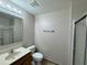 Bathroom featuring a sink, toilet, mirror, vanity, and glass enclosed shower at 1912 Conch Ln, Kissimmee, FL 34759