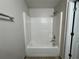Bathroom featuring a tub with white tiled walls at 1912 Conch Ln, Kissimmee, FL 34759