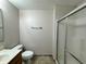Bathroom featuring a vanity, toilet, and a shower with sliding doors at 1912 Conch Ln, Kissimmee, FL 34759