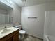 Bathroom featuring a wood vanity, a toilet, and a tub at 1912 Conch Ln, Kissimmee, FL 34759