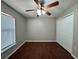 Bedroom featuring wood floors, a ceiling fan, and a closet at 1912 Conch Ln, Kissimmee, FL 34759