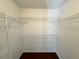 Walk-in closet featuring white wire shelving and wood floors at 1912 Conch Ln, Kissimmee, FL 34759