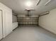 Garage featuring epoxy floors, built-in cabinets, and an automatic door at 1912 Conch Ln, Kissimmee, FL 34759