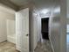 Hallway showcasing bathroom, laundry area, and bedroom access at 1912 Conch Ln, Kissimmee, FL 34759