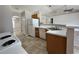 Bright kitchen featuring white appliances, tile floors, and an open layout at 1912 Conch Ln, Kissimmee, FL 34759