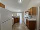 Kitchen with tile floors, white appliances, and ample cabinet space at 1912 Conch Ln, Kissimmee, FL 34759