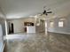 Open living area connecting to the kitchen, featuring tile floors and ample natural light at 1912 Conch Ln, Kissimmee, FL 34759