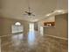 Spacious living room featuring tile flooring, a ceiling fan, and access to the backyard at 1912 Conch Ln, Kissimmee, FL 34759
