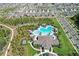 Community pool area with a large pool, clubhouse, lounge chairs, and lush landscaping at 1975 Cacutta Way, Kissimmee, FL 34744