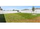 Well-maintained backyard featuring lush green grass and a white vinyl fence at 1975 Cacutta Way, Kissimmee, FL 34744