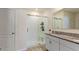 Modern bathroom with glass-enclosed shower, granite countertop vanity, and neutral color palette at 1975 Cacutta Way, Kissimmee, FL 34744