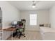 This bedroom has carpeted floors, a ceiling fan, a window, and a desk area at 1975 Cacutta Way, Kissimmee, FL 34744