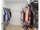 Walk-in closet features shelving and ample storage for clothes and personal belongings at 1975 Cacutta Way, Kissimmee, FL 34744