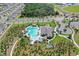 Aerial shot of a gorgeous community pool with winding walking paths and beautiful green spaces surrounding the pool at 1975 Cacutta Way, Kissimmee, FL 34744