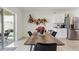 Bright dining area featuring a modern table, stylish decor, and seamless connection to kitchen space at 1975 Cacutta Way, Kissimmee, FL 34744