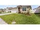Charming single-story home with well-manicured lawn and driveway leading to an attached two-car garage at 1975 Cacutta Way, Kissimmee, FL 34744