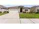 Attractive single-Gathering home with a two-car garage and landscaped front yard at 1975 Cacutta Way, Kissimmee, FL 34744
