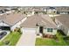 Aerial view of a single-Gathering home in a residential community with well-kept lawns at 1975 Cacutta Way, Kissimmee, FL 34744