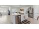 Modern kitchen featuring a granite island, stainless steel appliances, and open living area at 1975 Cacutta Way, Kissimmee, FL 34744