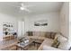 Inviting living room featuring a large sectional sofa, ceiling fan, and an open layout at 1975 Cacutta Way, Kissimmee, FL 34744