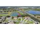 Aerial view showcasing a beautiful home by a lake, near a highway, with lush green scenery at 2019 Wintermere Pointe Dr, Winter Garden, FL 34787
