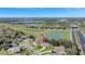 Aerial view of a home near a tranquil lake and green spaces, surrounded by lush trees at 2019 Wintermere Pointe Dr, Winter Garden, FL 34787