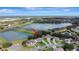 Aerial view of a neighborhood home near a peaceful lake and green areas, next to the highway at 2019 Wintermere Pointe Dr, Winter Garden, FL 34787