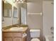 Bathroom featuring granite vanity, tiled walls, toilet, and vanity lighting at 2019 Wintermere Pointe Dr, Winter Garden, FL 34787