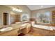 Well-lit primary bathroom boasts a soaking tub, walk-in shower, and double sink vanity at 2019 Wintermere Pointe Dr, Winter Garden, FL 34787