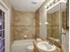 Bathroom showcasing tile walls, tub and shower combination, and granite countertop vanity at 2019 Wintermere Pointe Dr, Winter Garden, FL 34787
