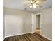 Neutral bedroom boasts wood-look floors and a ceiling fan, creating a comfortable and inviting space at 2019 Wintermere Pointe Dr, Winter Garden, FL 34787