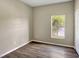 Bedroom featuring wood-look flooring, neutral walls, a window and a closet at 2019 Wintermere Pointe Dr, Winter Garden, FL 34787