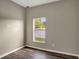 Bedroom featuring wood-look flooring, neutral walls and a window overlooking a fenced backyard at 2019 Wintermere Pointe Dr, Winter Garden, FL 34787